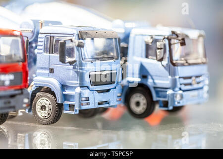 Miniature trucks stand in a glass cabinet Stock Photo