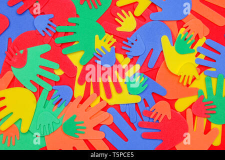 Funky foam hands of different sizes in red, orange, yellow, green and blue on a plain background Stock Photo