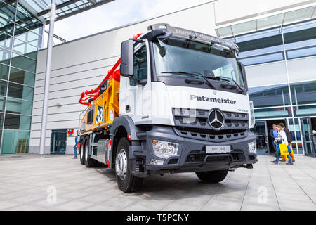 MUNICH / GERMANY - APRIL 14, 2019: Mercedes Benz truck with a concrete pump stands in front of a hall in Munich. Stock Photo