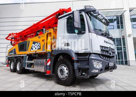 MUNICH / GERMANY - APRIL 14, 2019: Mercedes Benz truck with a concrete pump stands in front of a hall in Munich. Stock Photo