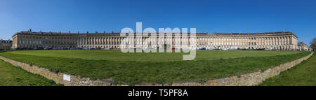 BATH, England - APRIL19, 2019: Royal Crescent, Georgian Houses Architecture with windows pillars, lamp post on a sunny day with clear sky. Stock Photo
