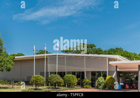 Darwin Australia - February 22, 2019: Military Museum set in green environment under blue sky. Flags in front. Stock Photo