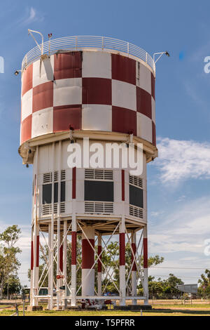 Darwin Australia - February 22, 2019: Red and white Tower of Australian Aviation Heritage Centre against blue sky. Some green vegetation. Stock Photo