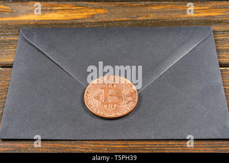 Black closed envelope on light blue background. Stock Photo