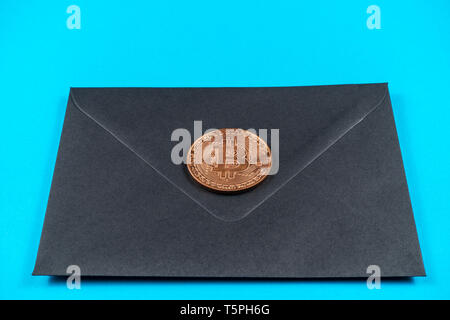 Black closed envelope on light blue background. Stock Photo