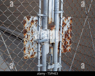 Rusty outdoor gate handle door and key lock with weathered appearance old Stock Photo