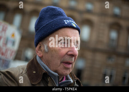 Glasgow, Scotland, 26th April 2019. 78-years old Jim Gillies stands in George Square with his placard remembering the 1986 Chernobyl nuclear disaster in the Ukraine. Today marks the 33rd anniversary of the disaster and Jim Gillies has marked the disaster day, by standing with his placard in the Square ever year since, as well as donating more than £20,000 GBP to a hospital in Ukraine, a country he has now visited approximately 20 times. Credit: jeremy sutton-hibbert/Alamy Live News Stock Photo