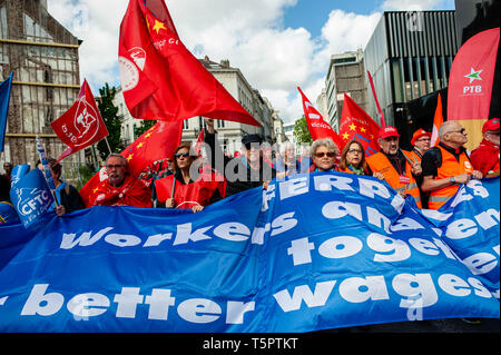 A Group Of Workers Seen Holding A Huge Banner And Flags During The
