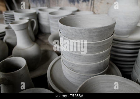 FEZ, MOROCCO - November 1, 2012: Handmade pottery goods stacked in columns in a pottery workshop in Fez, Morocco. Stock Photo