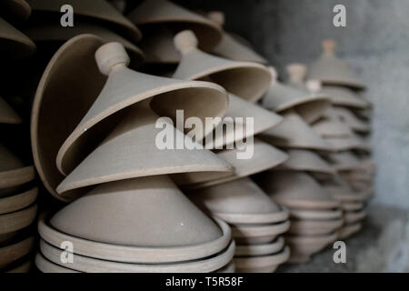 FEZ, MOROCCO - November 1, 2012: Handmade pottery goods stacked in columns in a pottery workshop in Fez, Morocco. Stock Photo