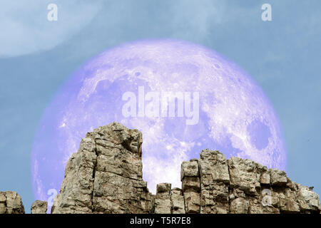 super moon back over stone on rock of cliff, Elements of this image furnished by NASA Stock Photo
