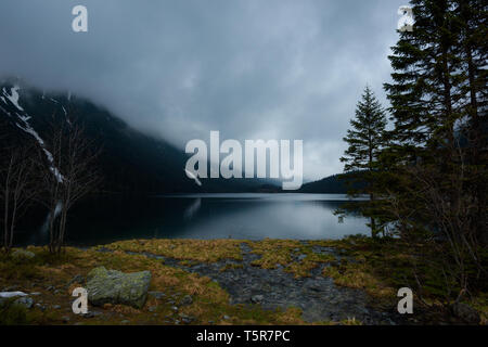 Dramatic weather on mountain lake shore before the storm Stock Photo