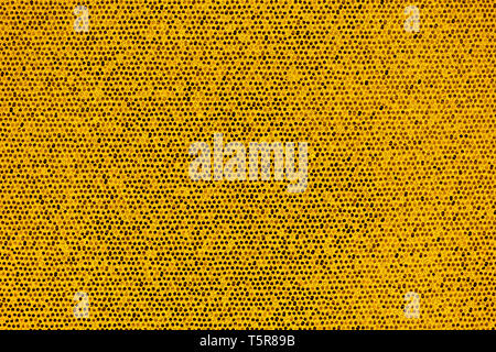 Bright golden artificial scales and glitter in small combs abstract background Stock Photo