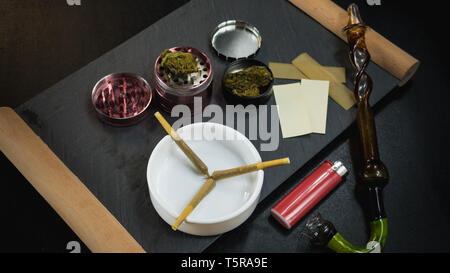 Marijuana joints lie in the ashtray. Smoking pipe, grinder, cannabis. Cannabis is herbal medicine Stock Photo