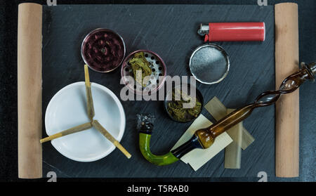 Marijuana joints lie in the ashtray. Smoking pipe, grinder, cannabis. Cannabis is herbal medicine Stock Photo