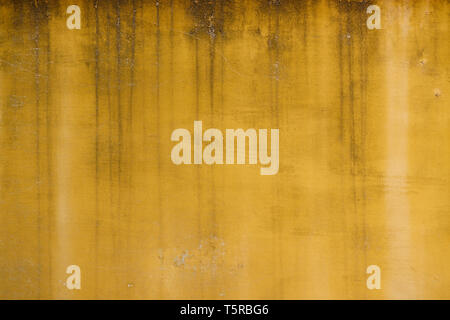 Old weathered yellow painted stucco wall texture Stock Photo