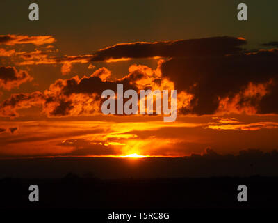 Orange clouds in the fiery sunset in Bedfordshire UK, looking towards Milton Keynes Stock Photo