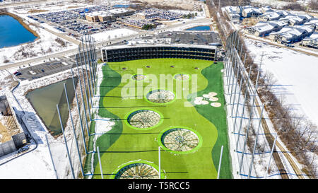 A drone / aerial view of TopGolf. Topgolf features three floors of driving range bays and is a fun entertainment complex for all ages to enjoy. Stock Photo