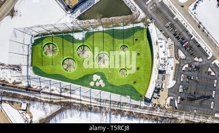 A drone / aerial view of TopGolf. Topgolf features three floors of driving range bays and is a fun entertainment complex for all ages to enjoy. Stock Photo