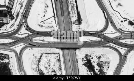 A drone / aerial view of a highway ramps with vehicles driving. Stock Photo