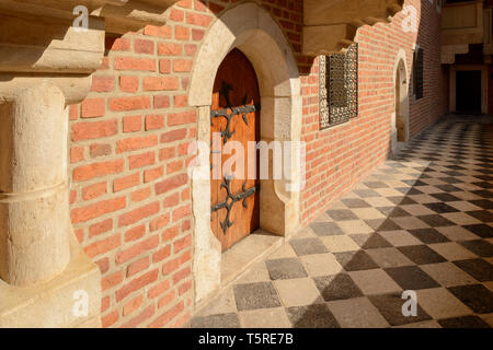 A wooden doorway and balcony in the courtyard of Collegium Maius in Krakow, Poland Stock Photo