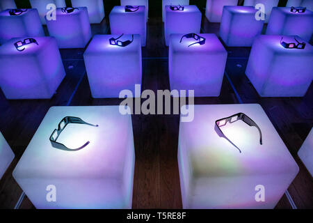 Coloured cubes with 3D glasses resting on them inside a cinema in Poland. Stock Photo