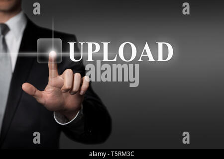 technology, internet, network, business concept - businessman in suit presses virtual touchscreen interface button - english word UPLOAD Stock Photo