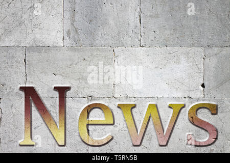 News carved on white stone wall - concept image with upper space for text Stock Photo