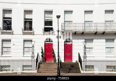 Two red doors in the Terrace of Georgian houses on the Royal Crescent Cheltenham Spa Gloucestershire England GB UK EU Europe Stock Photo
