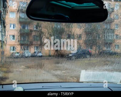 Abstract traffic in raining day. View from car seat. Background in retro filter. Stock Photo