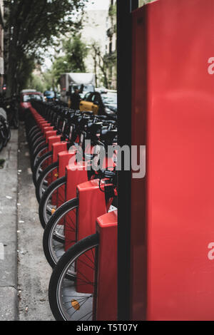 Barcelona, Spain. 15 April 2019. Bicing - Barcelona's bicycle hire system, stack of red cycles on the street. Stock Photo