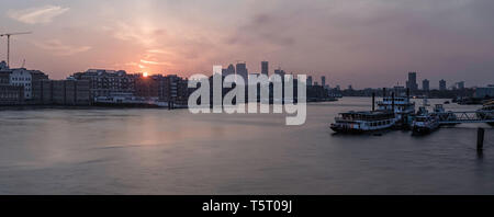 Early morning sunrise near Tower Bridge at central London with riverside view and boats at river Thames. Stock Photo