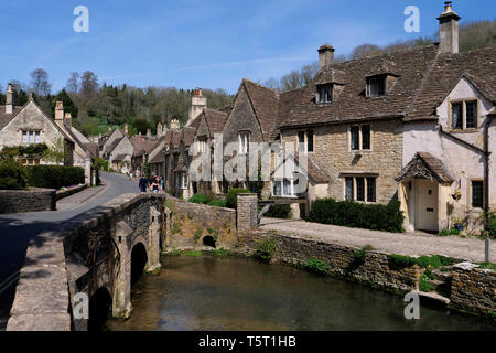 View of the river Bybrook and arched stone built bridge in Castle Coombe The Cotswolds Wiltshire England Stock Photo