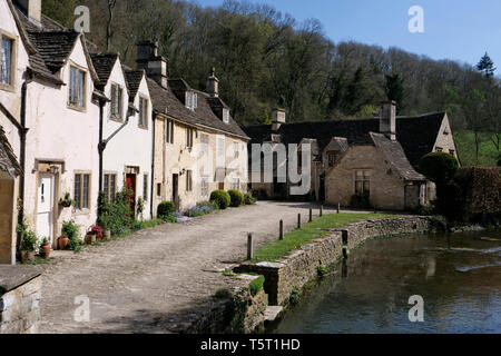 View of the river Bybrook and Cotswold Stone cottages in Water Lane Castle Coombe The Cotswolds Wiltshire England Stock Photo