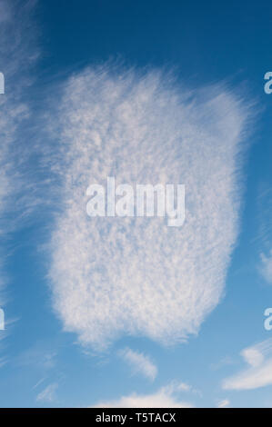 Cirrus clouds with unusual shapes in blue sky. Stock Photo