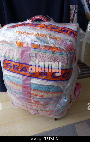 Seal and Go airline luggage wrapping Stock Photo