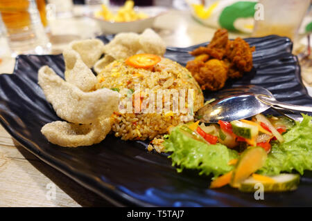 Fried rice with fish crackers and fried chicken with salad Stock Photo