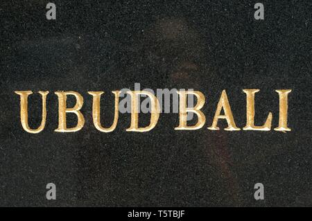 Golden Text UBUD - BALI written on a Black Marble slab captured in Ubud, Bali - Indonesia Stock Photo