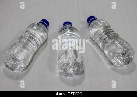 Plastic water bottle lying on bed. Stock Photo