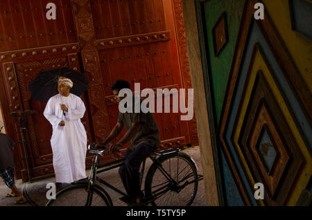 Omani men wearing traditional Arab clothes in the Souk at Nizwa, Oman Stock Photo