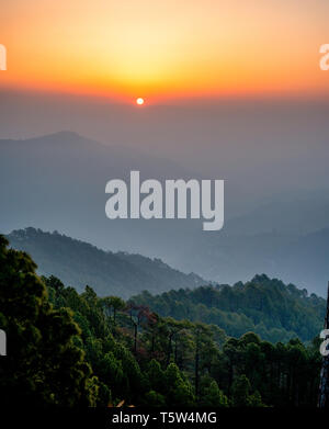 Sunrise over the pine forested hills of the Binsar region of the Himalayan foothills in Uttarakhand Northern India Stock Photo