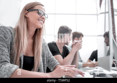 young colleagues working in the office using computers Stock Photo