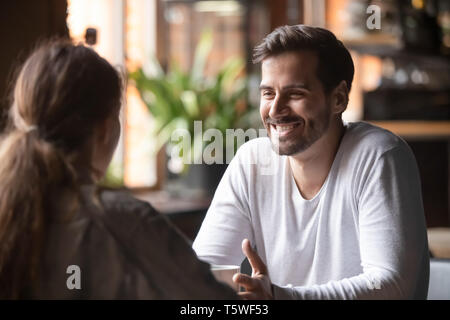 Rear view female sitting at speed dating with smiling man Stock Photo