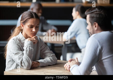 Shy or bored woman sitting with man on speed dating Stock Photo