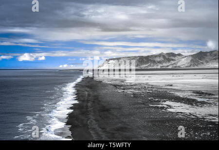 The black sand beach of Reynisfjara on Iceland’s South Coast is one of the most unique beaches in the world.  It was created by lava flowing into the  Stock Photo