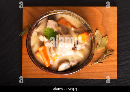 Classic French food concept Blanquette de Veau or Veal in White Wine Sauce in handmade ceramic cup with copy space