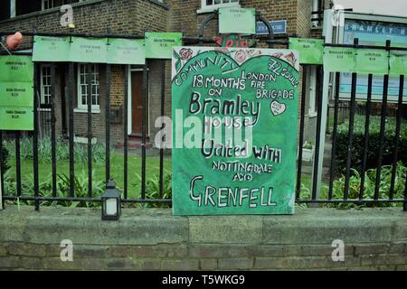 Bramley House Residents make a memorial banner in remembrance of Grenfell victims. The green banner  is displayed on railings locally. Stock Photo