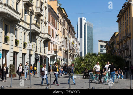 Milan, Italy -  March 31, 2019:  People walk along Corso Como, old trendy pedestrian street near Porta Nuova district,  Lombardy Stock Photo