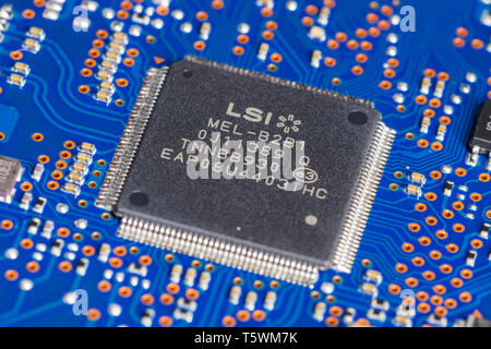 LSI Quad Flat Pack package type of surface mount technology (SMT) chip mounted on a PCB. Stock Photo
