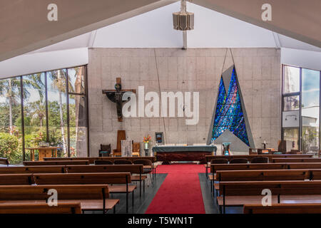 Darwin Australia - February 22, 2019: Inside the modern building of Christ Cathedral shows contemporary shapes, benches, altar and cross with windows  Stock Photo